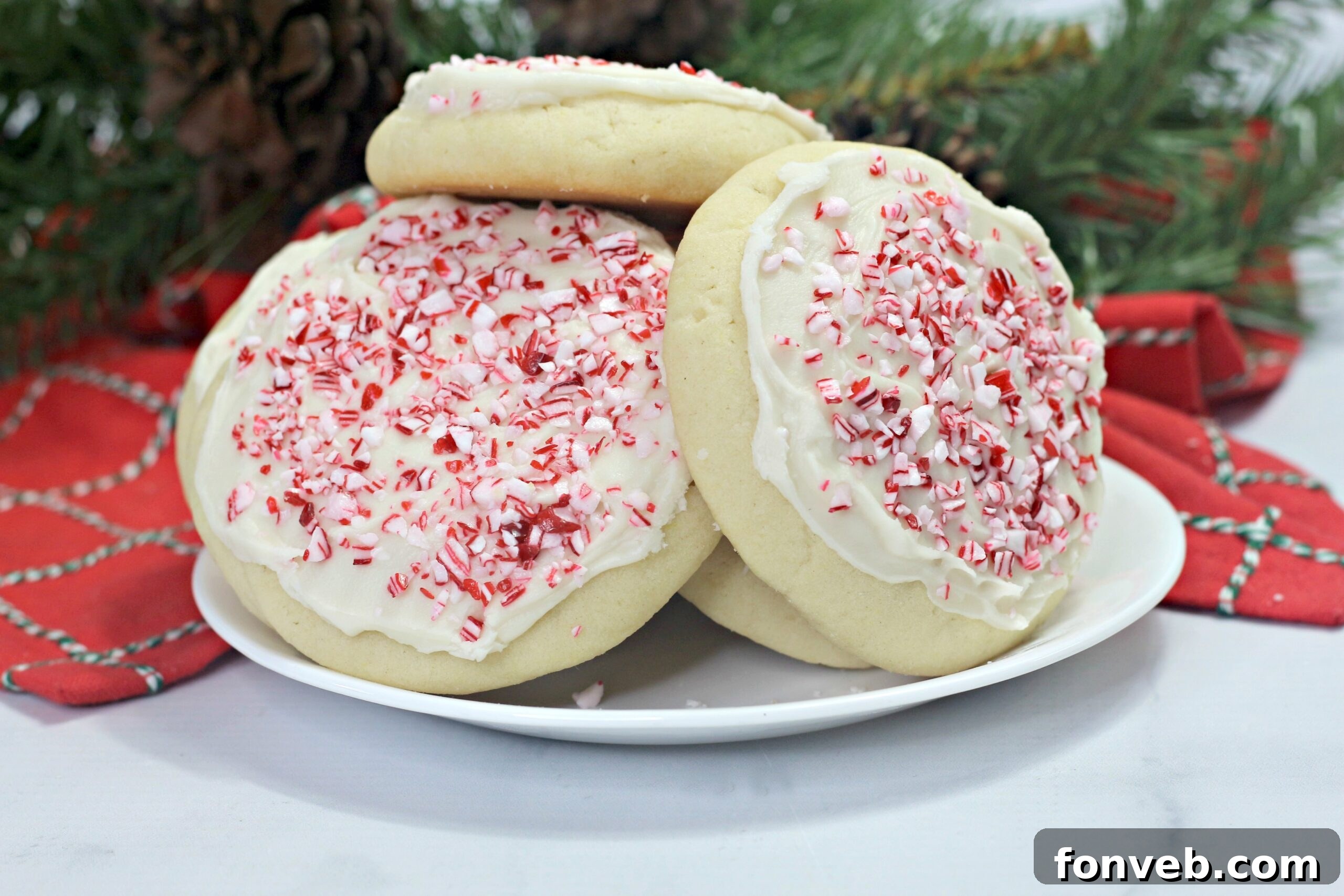 A platter of beautifully decorated Amish Sugar Cookies, some with white frosting and candy cane bits, others with colorful sprinkles, perfect for holiday gifting or dessert tables.