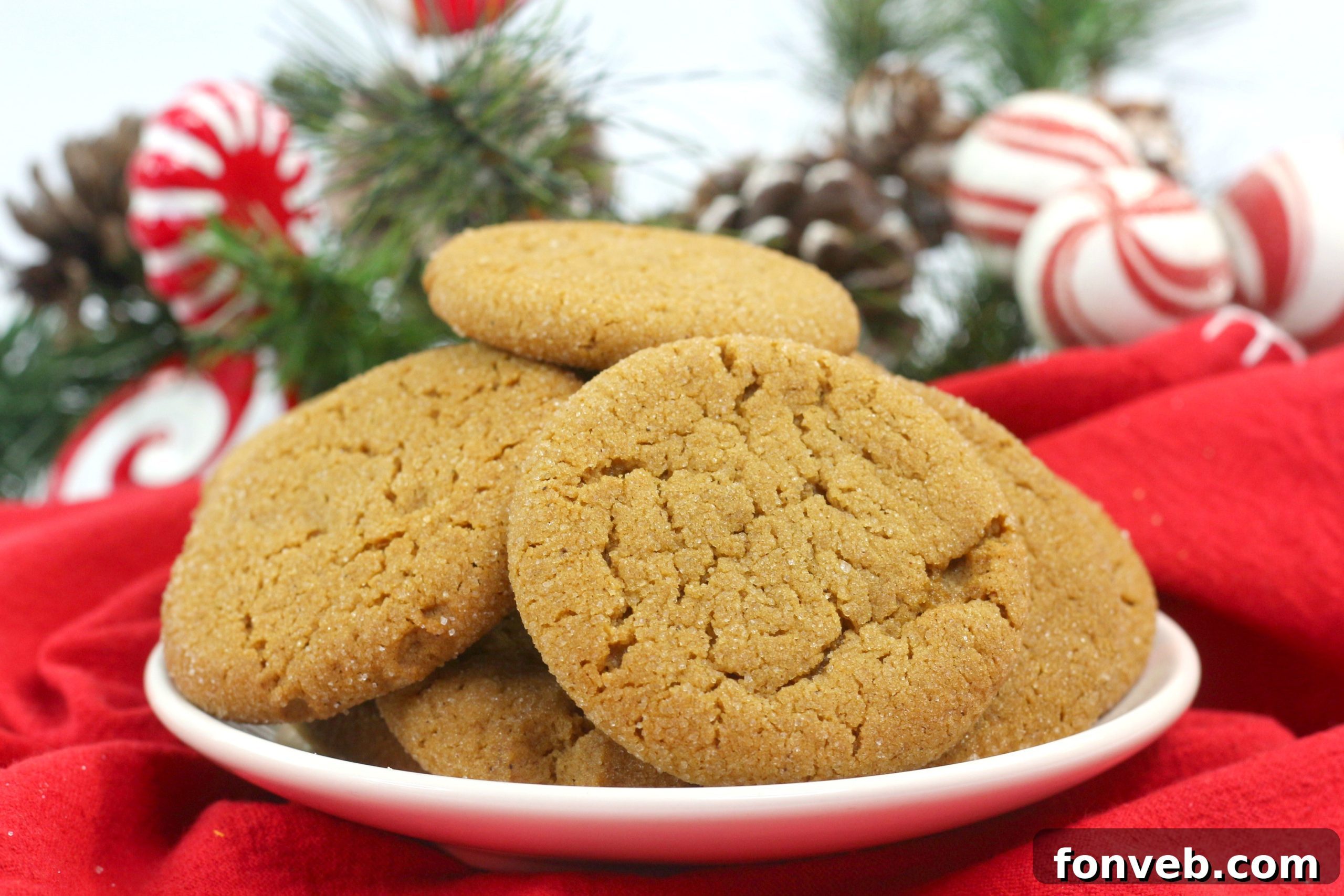 A stack of soft batch gingerbread cookies, perfectly round and coated in sugar, ready for a festive treat.