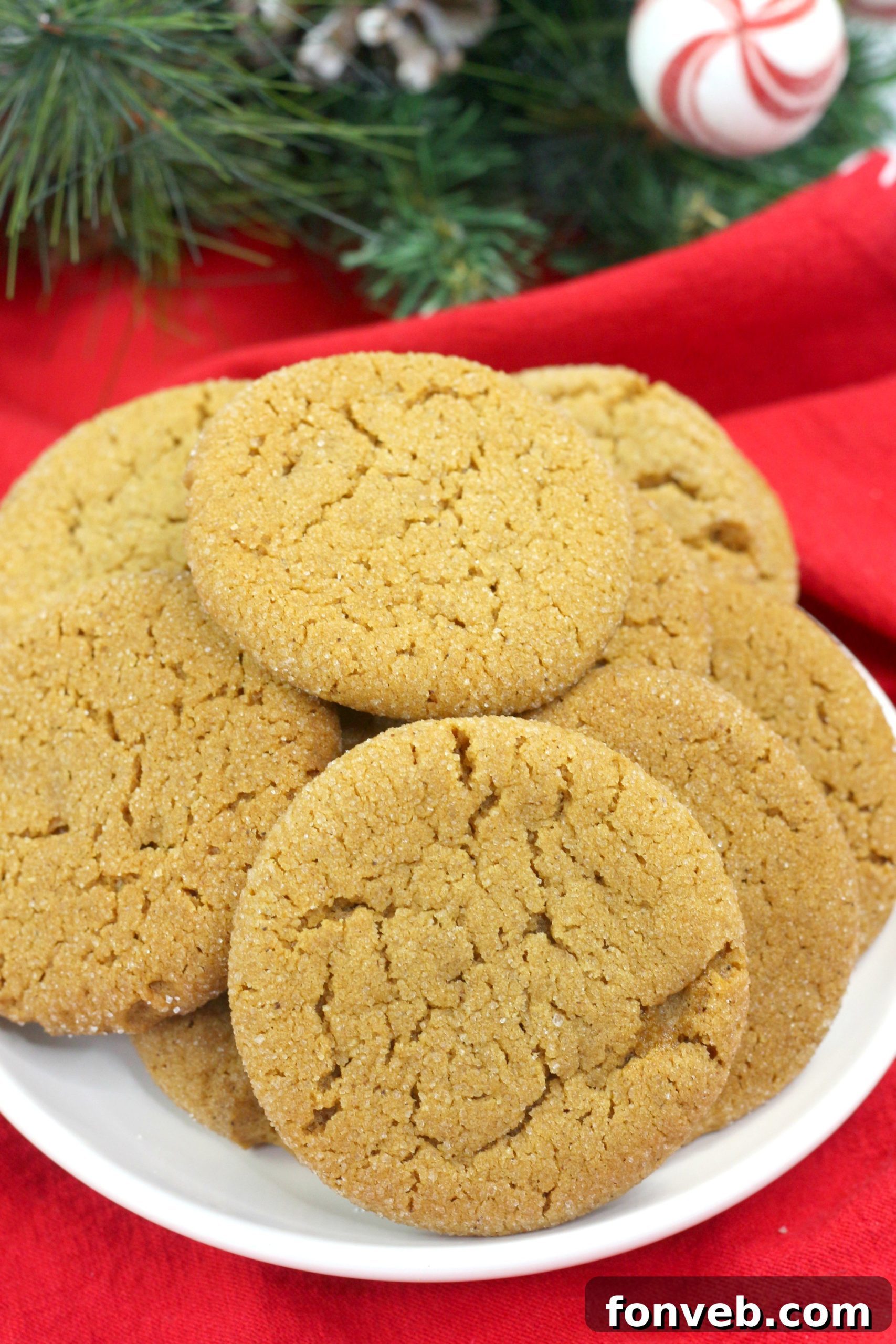 An overhead shot showcasing a plate of generously sized, soft batch gingerbread cookies, emphasizing their delightful round shape and sugar coating.