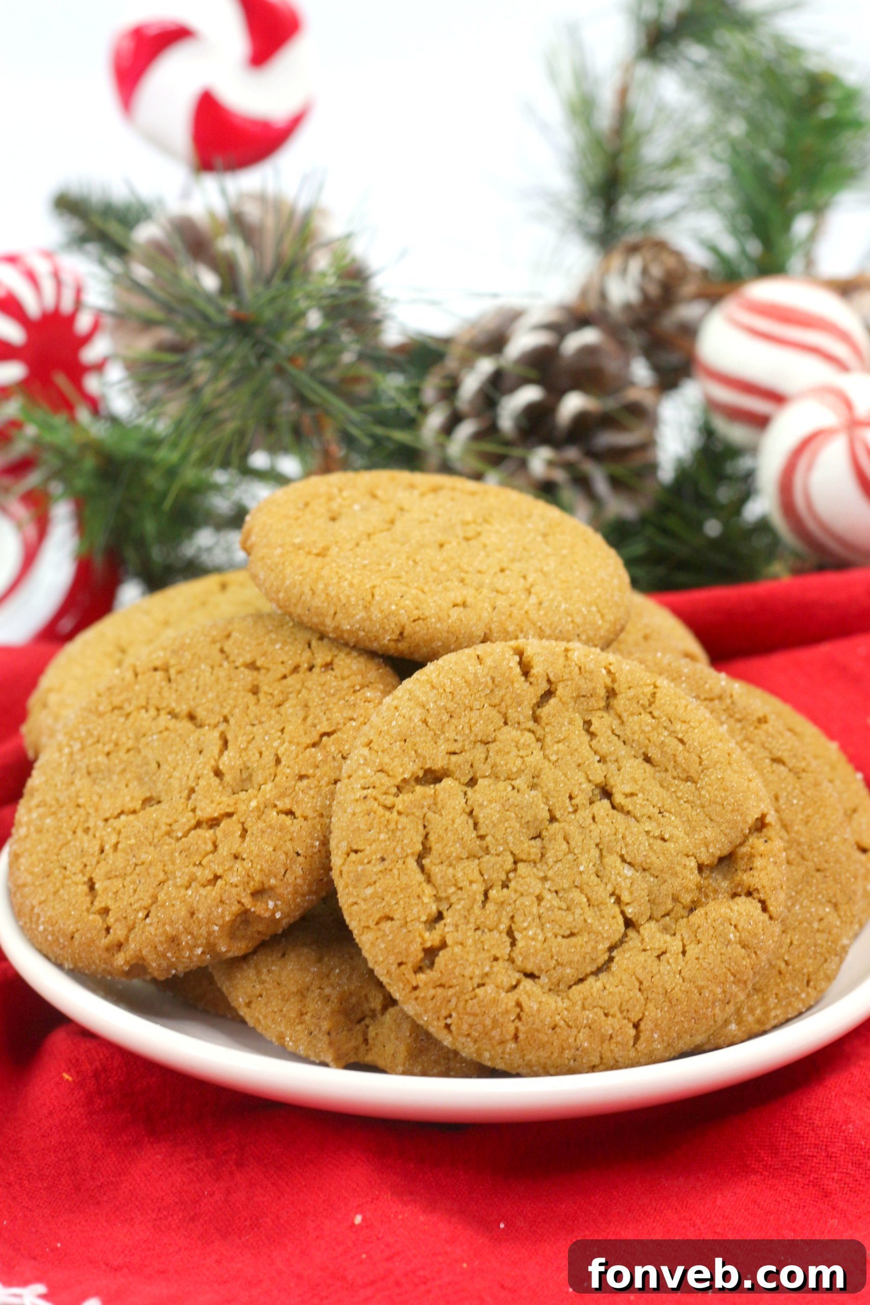 A close-up view of a hand holding a soft batch gingerbread cookie, highlighting its texture and inviting appearance.