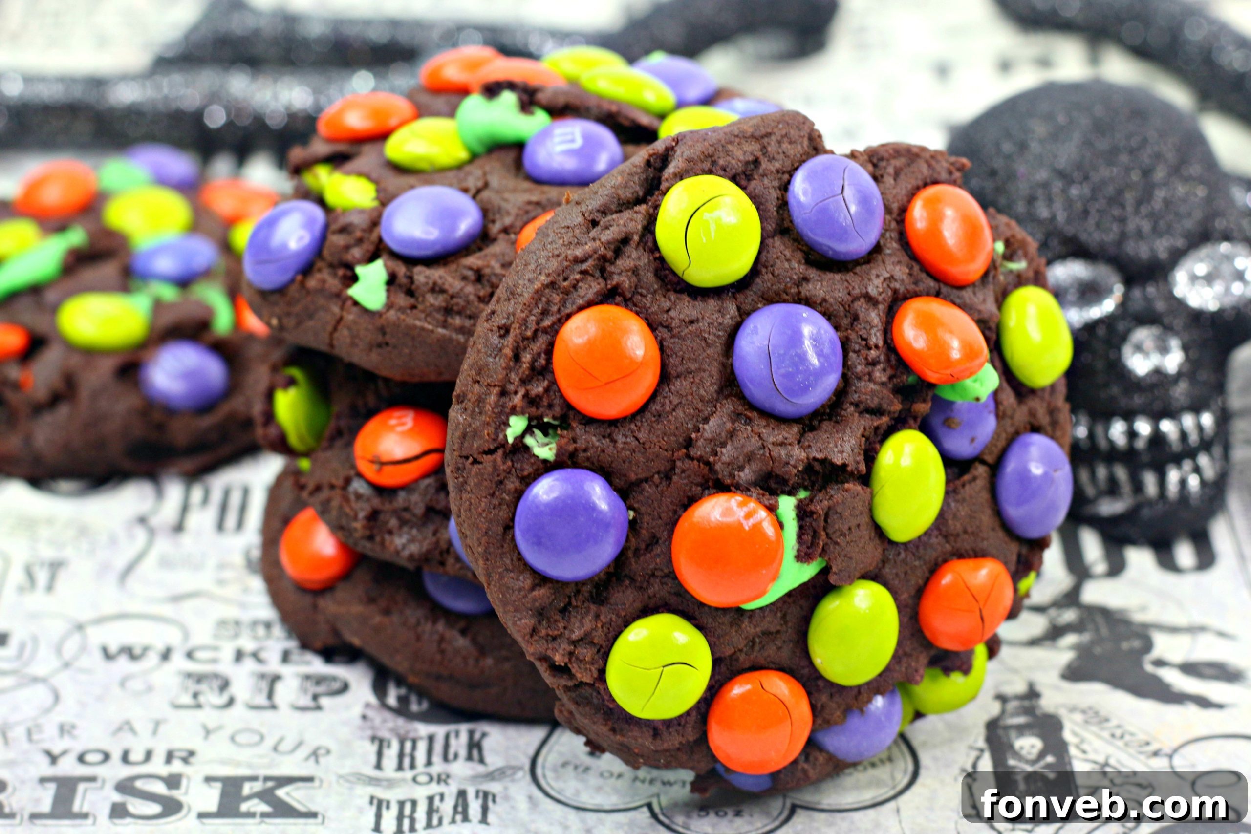 A close-up overhead shot of a batch of Monster Mash Chocolate Cookies cooling on a wire rack.