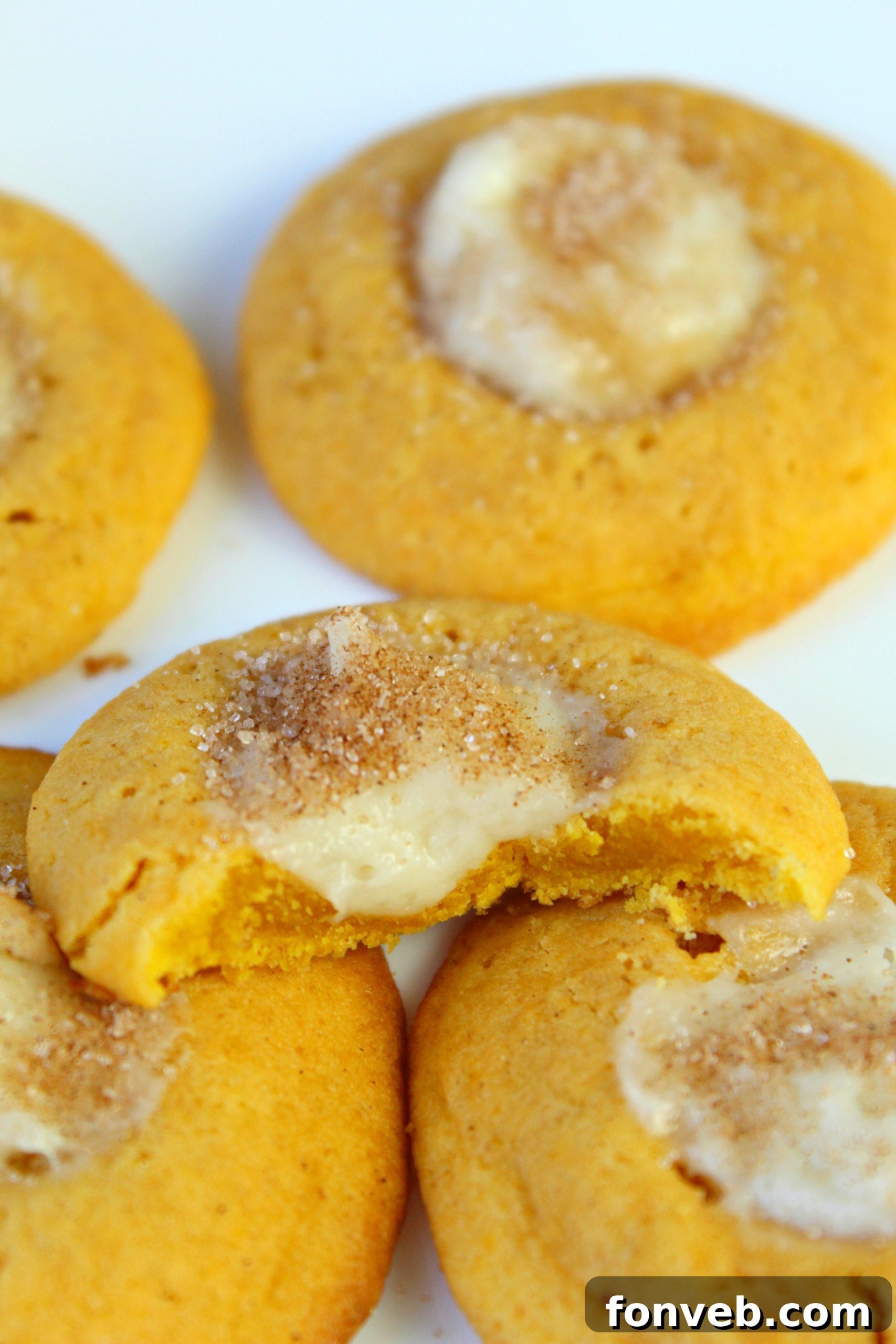 Close-up of a single Pumpkin Cheesecake Thumbprint Cookie showcasing its soft texture and creamy filling.