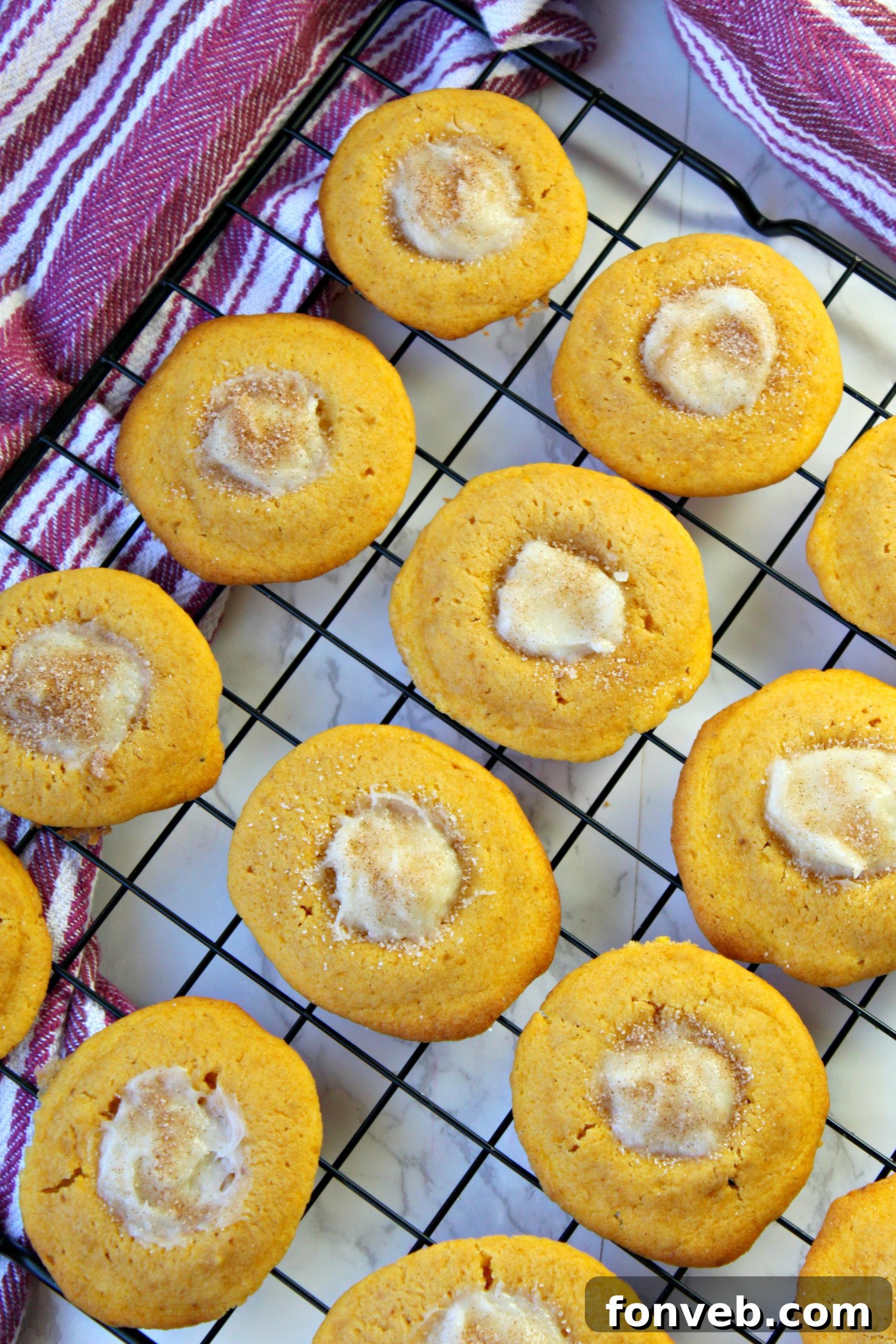 A plate of several Pumpkin Cheesecake Thumbprint Cookies, beautifully arranged and ready to be served.