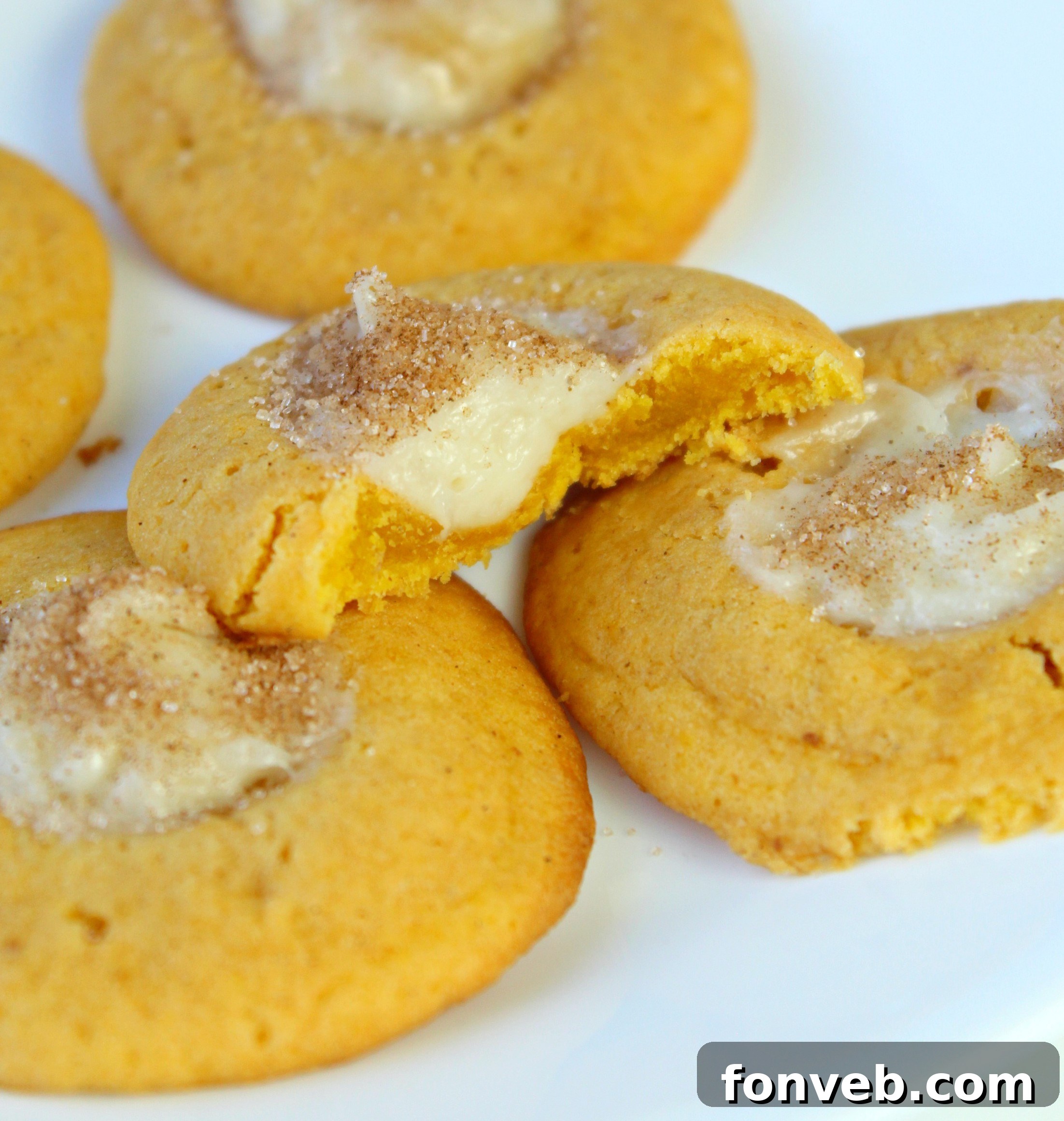 Various Pumpkin Cheesecake Thumbprint Cookies arranged artfully, highlighting their inviting, homemade appearance.